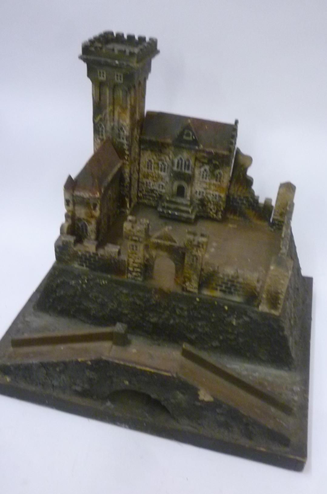 A painted wood castle dismantling into sections on base Image