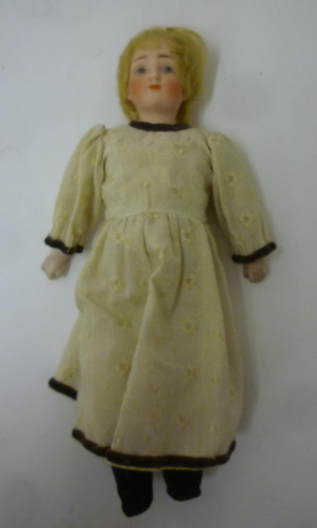 A German bisque shoulder head doll with fixed blue glass eyes Image