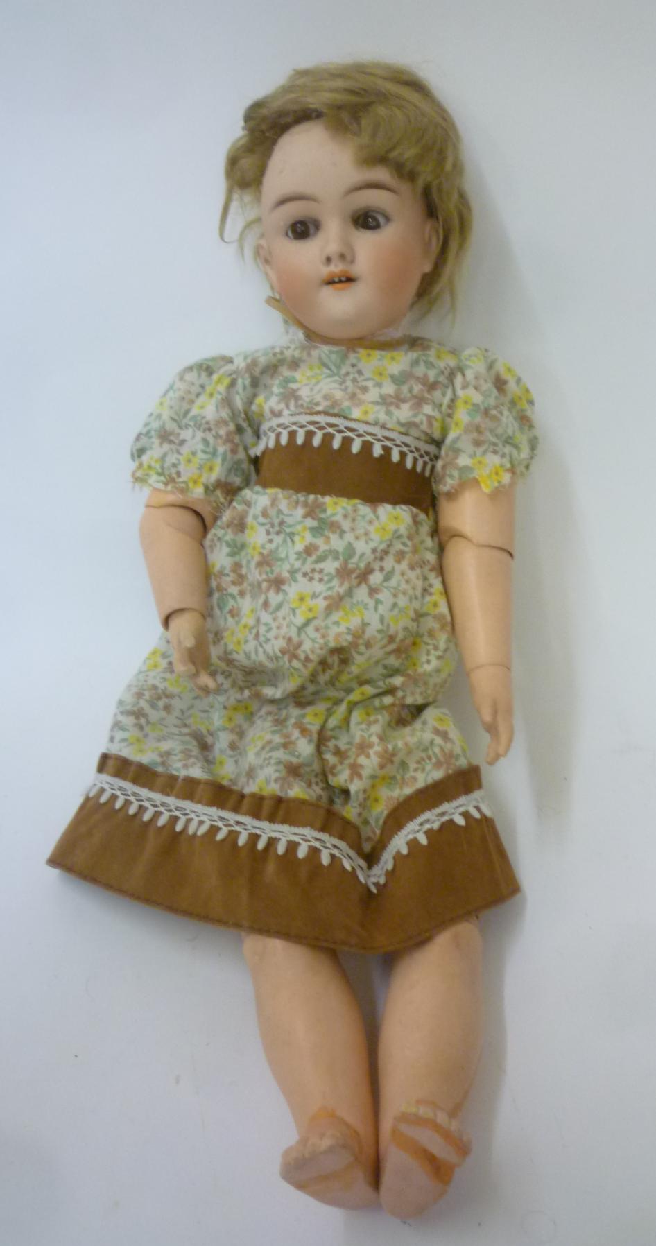 A Max Handwerck bisque head doll with sleeping brown glass eyes Image