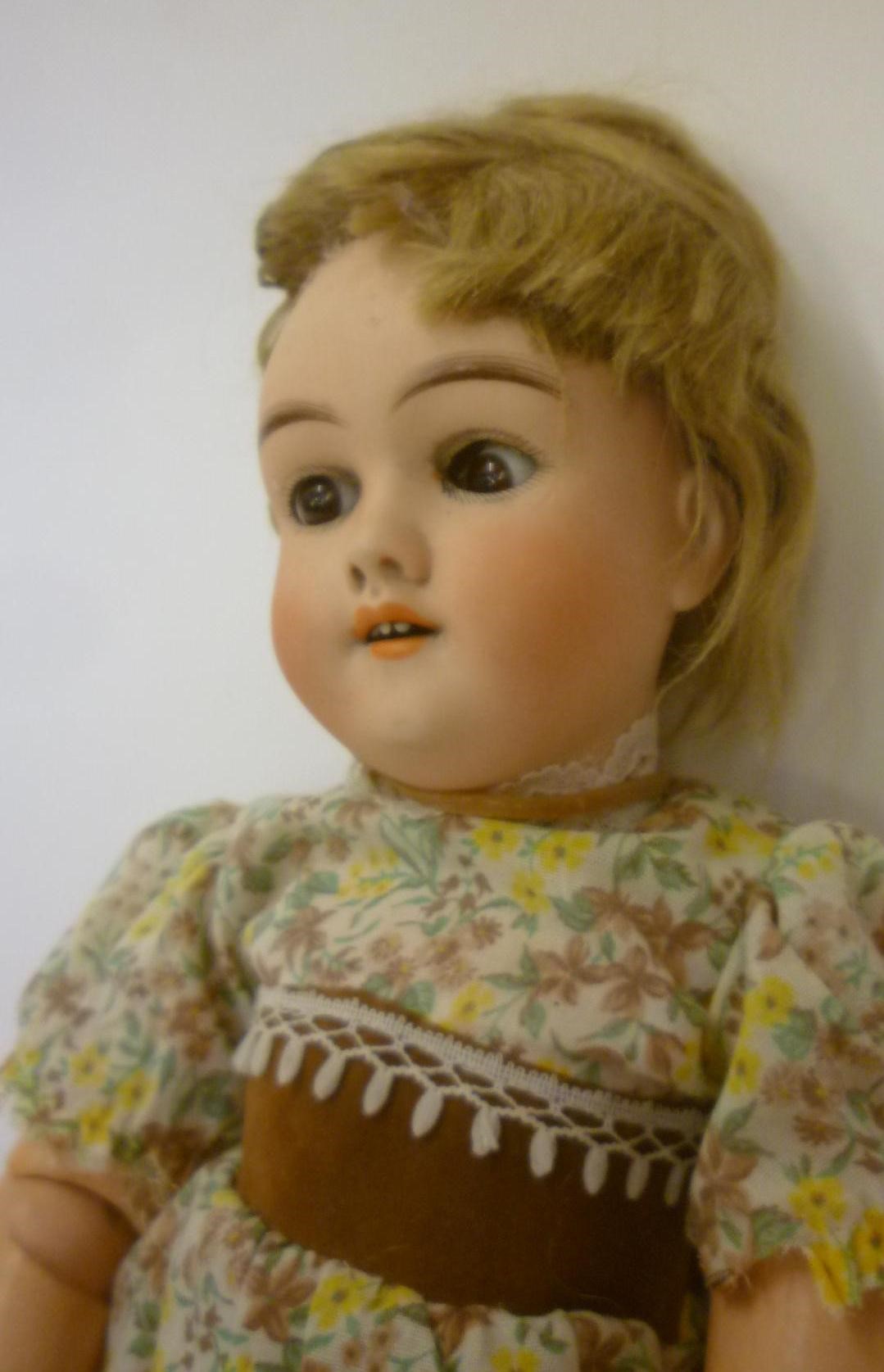 A Max Handwerck bisque head doll with sleeping brown glass eyes Image