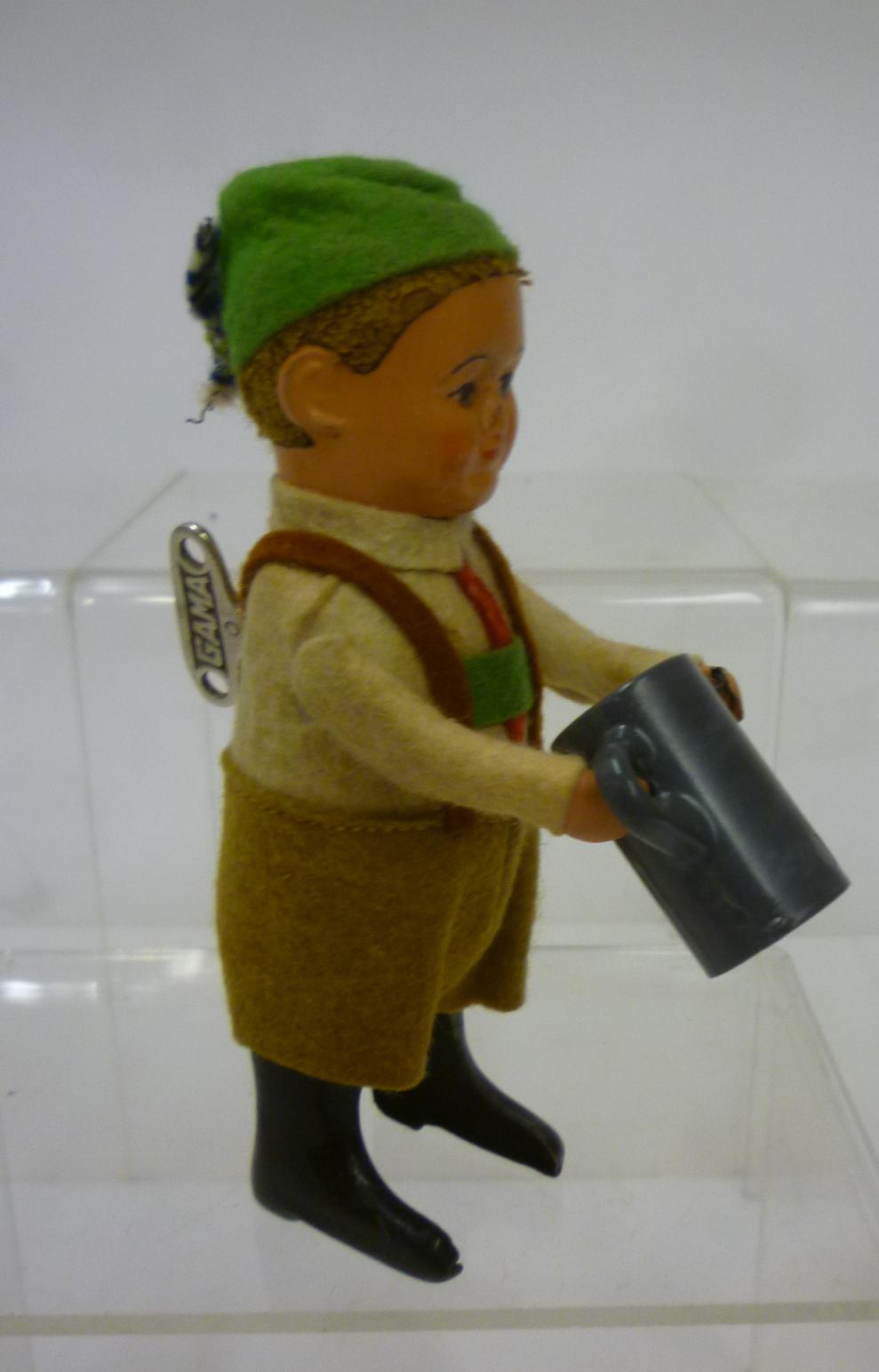 A Schuco tinplate and composition Drinking Boy Image