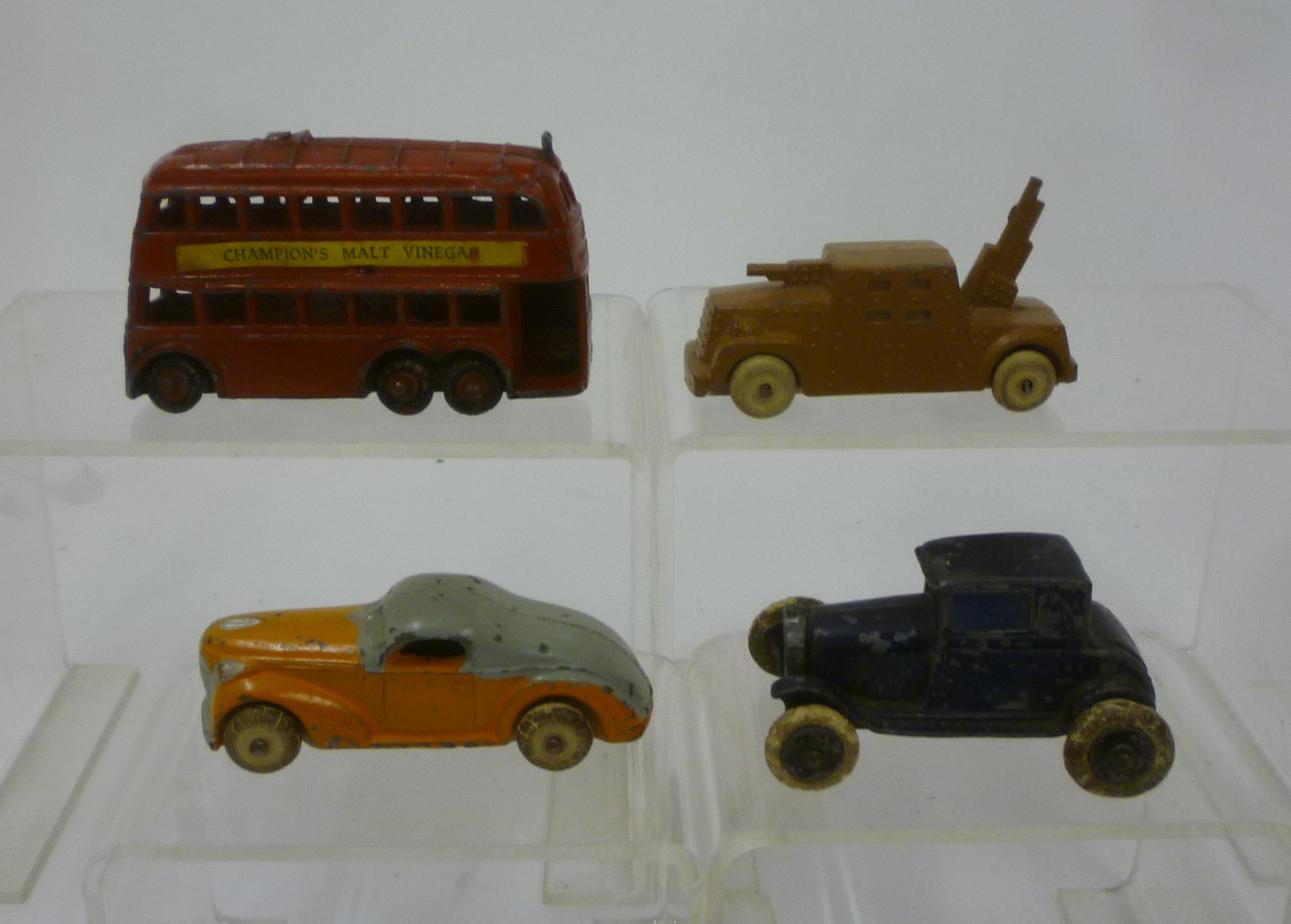 Four early Taylor & Barrett metal vehicles comprising six wheel doubledecker trolley bus Image
