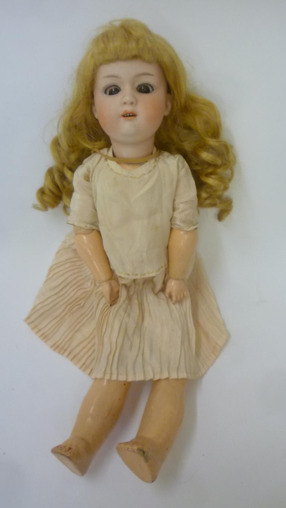 A Gebruder Heubach bisque head character doll with brown glass sleeping eyes Image