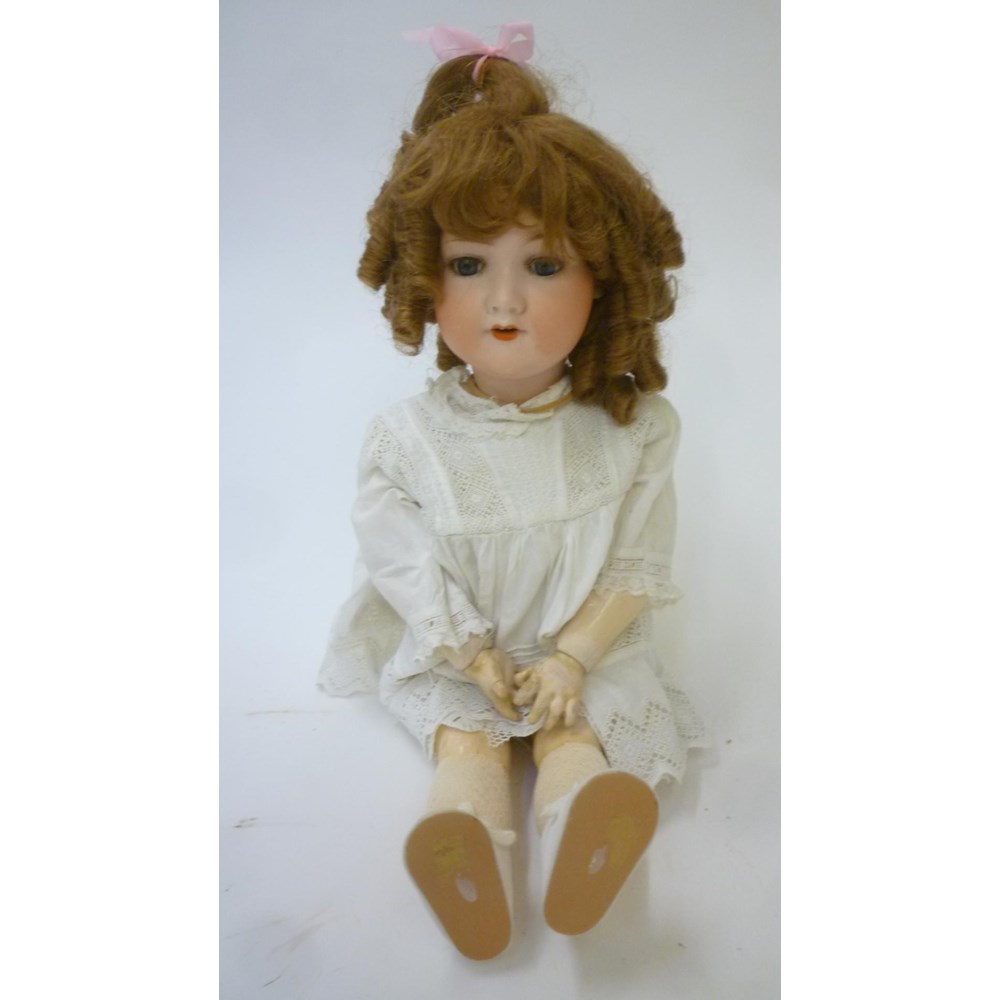 An Armand Marseille bisque head doll with blue glass sleeping eyes Image