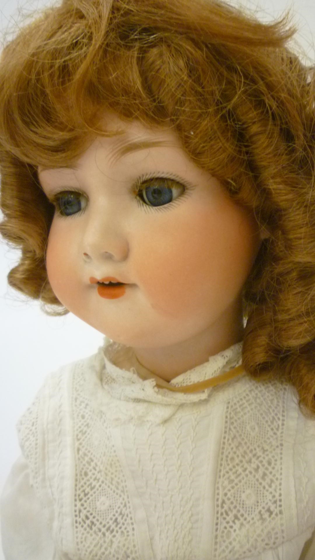 An Armand Marseille bisque head doll with blue glass sleeping eyes Image