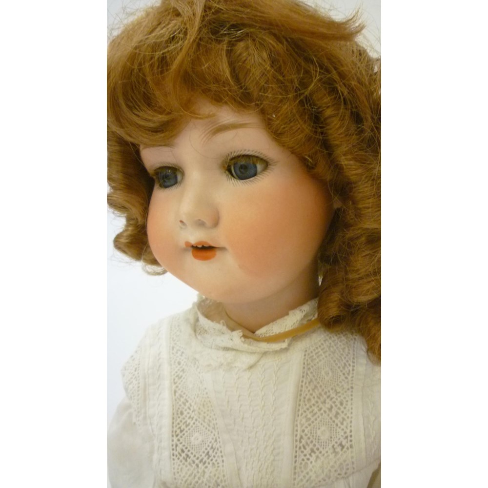 An Armand Marseille bisque head doll with blue glass sleeping eyes Image