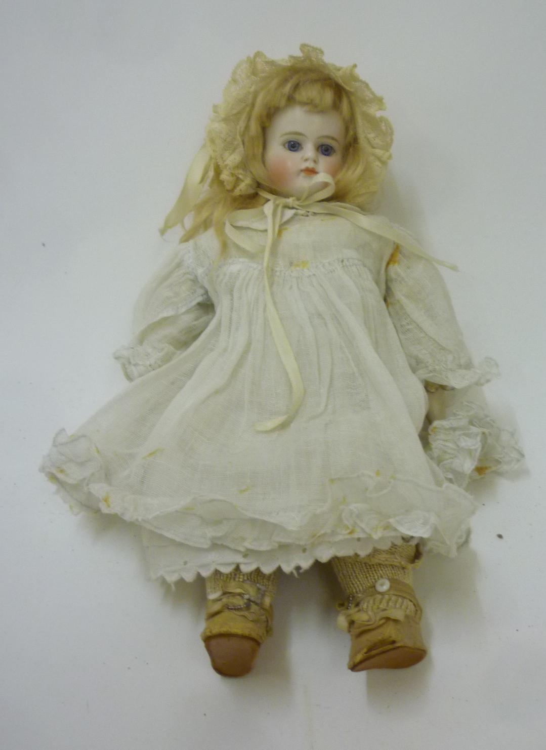 A Belton bisque shoulder head doll with fixed blue glass eyes Image
