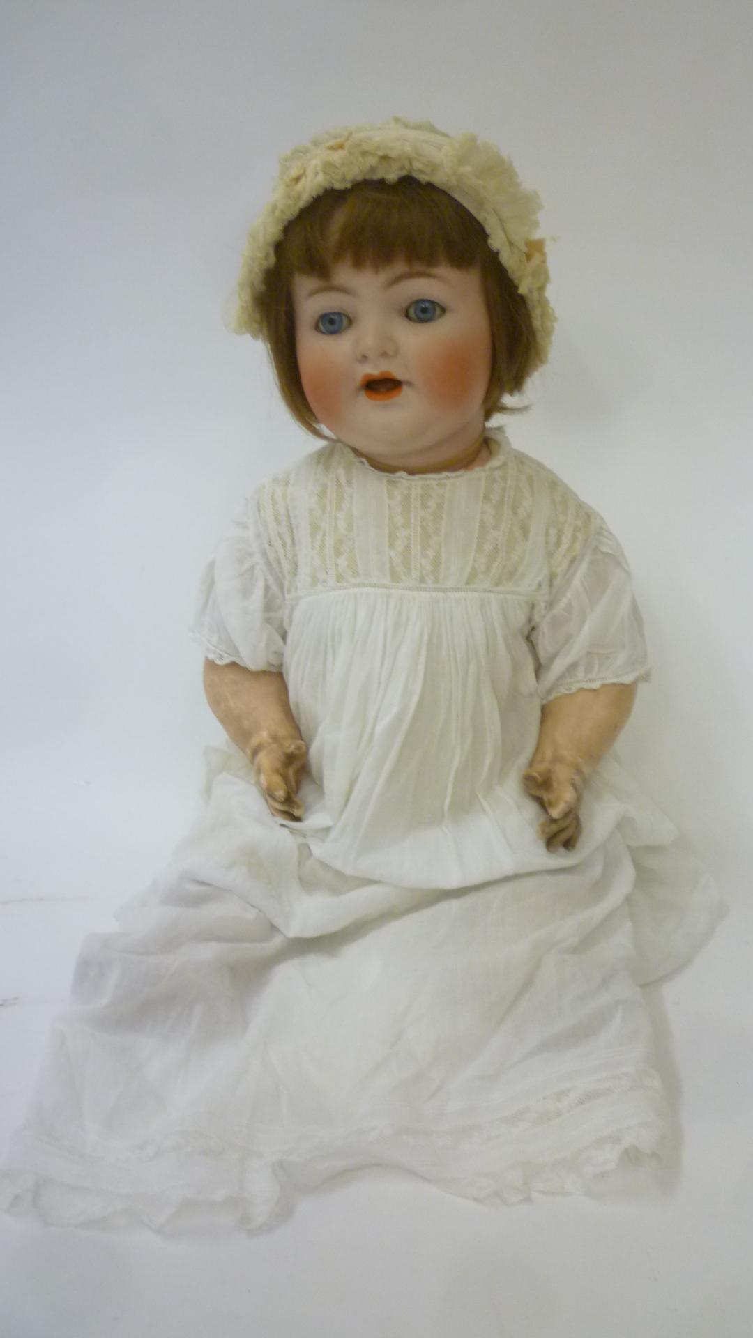 A Kammer & Reinhardt bisque head character doll with blue glass sleeping eyes Image