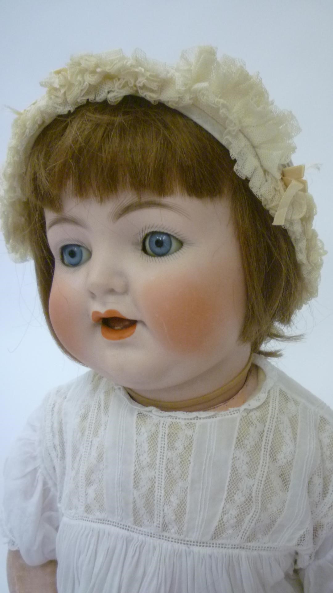 A Kammer & Reinhardt bisque head character doll with blue glass sleeping eyes Image