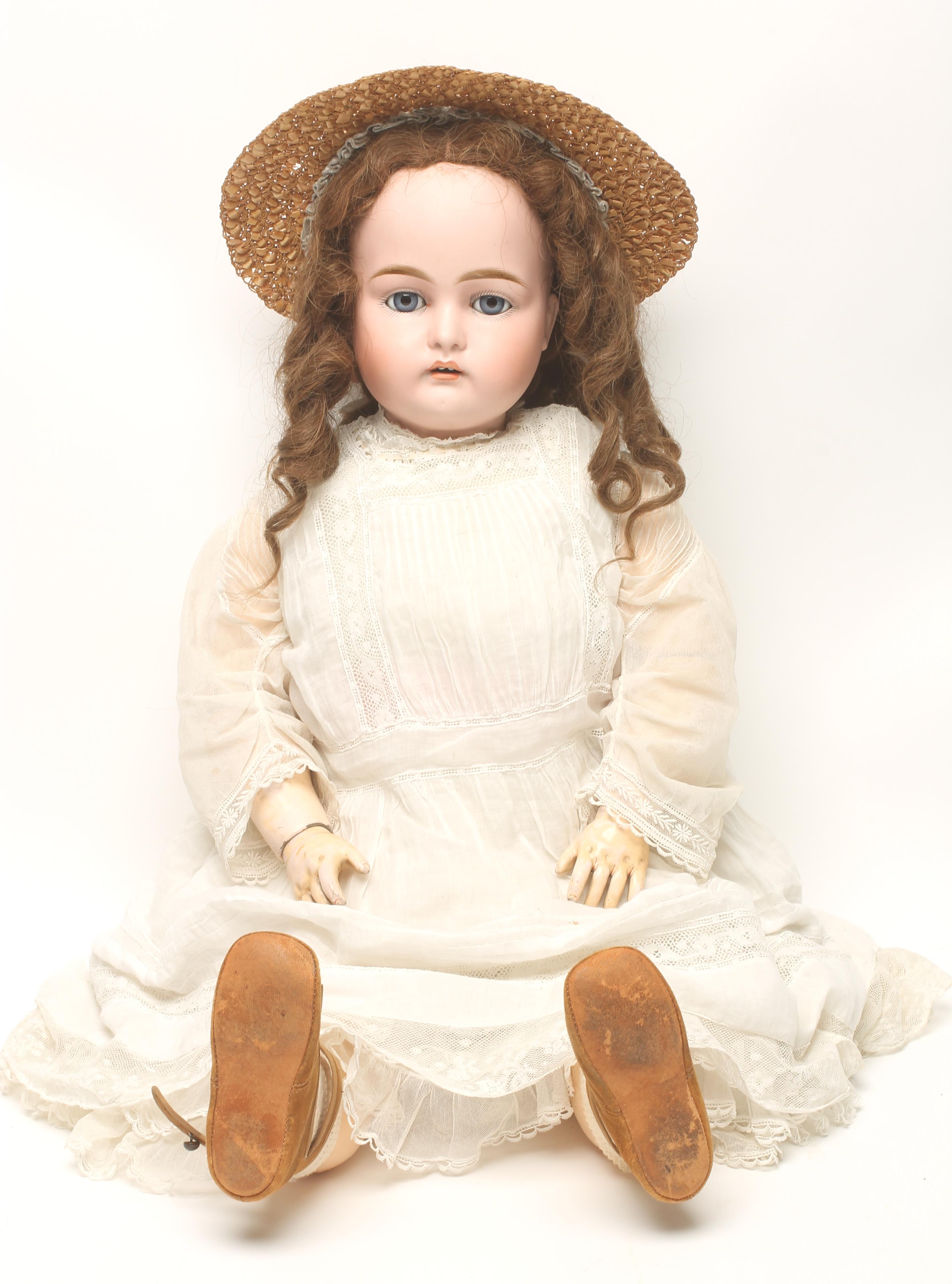 A Kestner bisque head doll with blue glass sleeping eyes Image