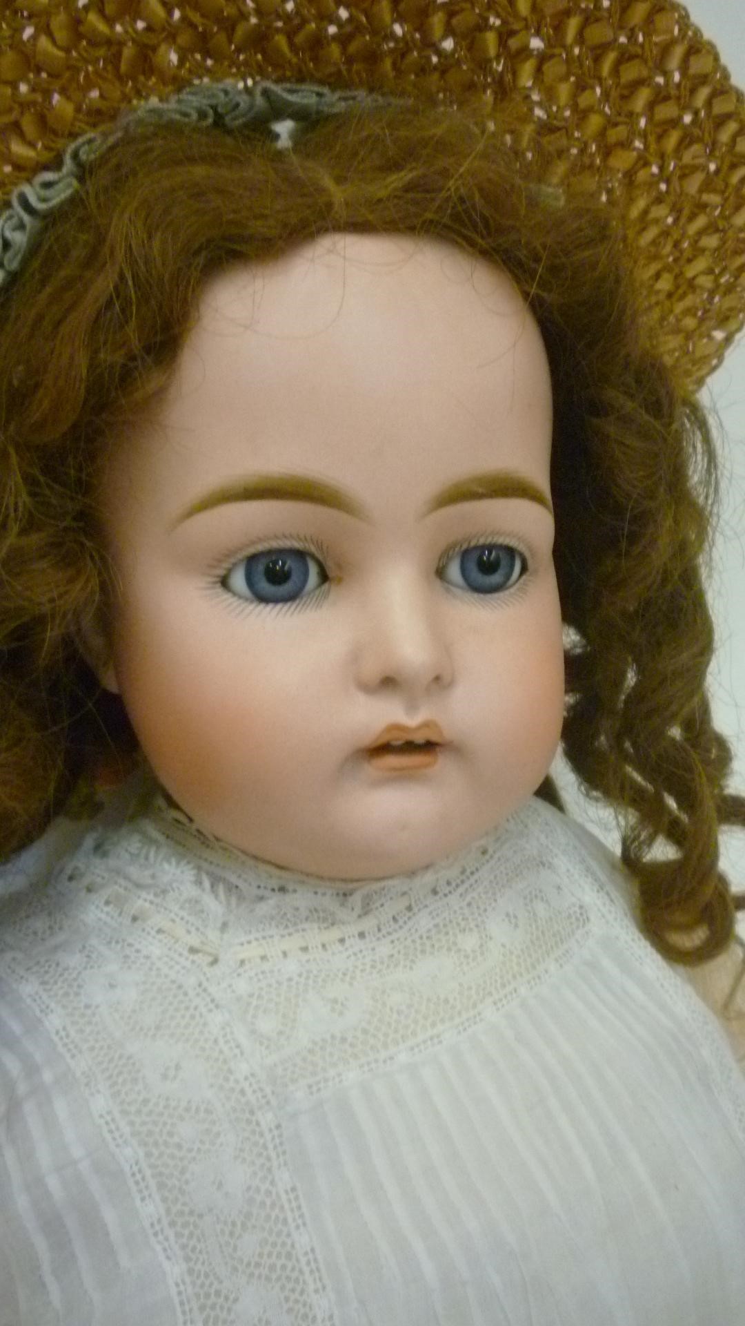 A Kestner bisque head doll with blue glass sleeping eyes Image