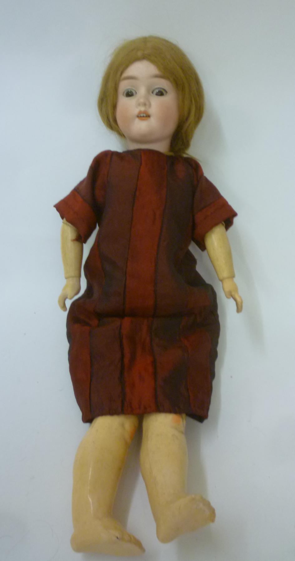 A Heinrich Handwerck bisque head doll with brown glass sleeping eyes Image