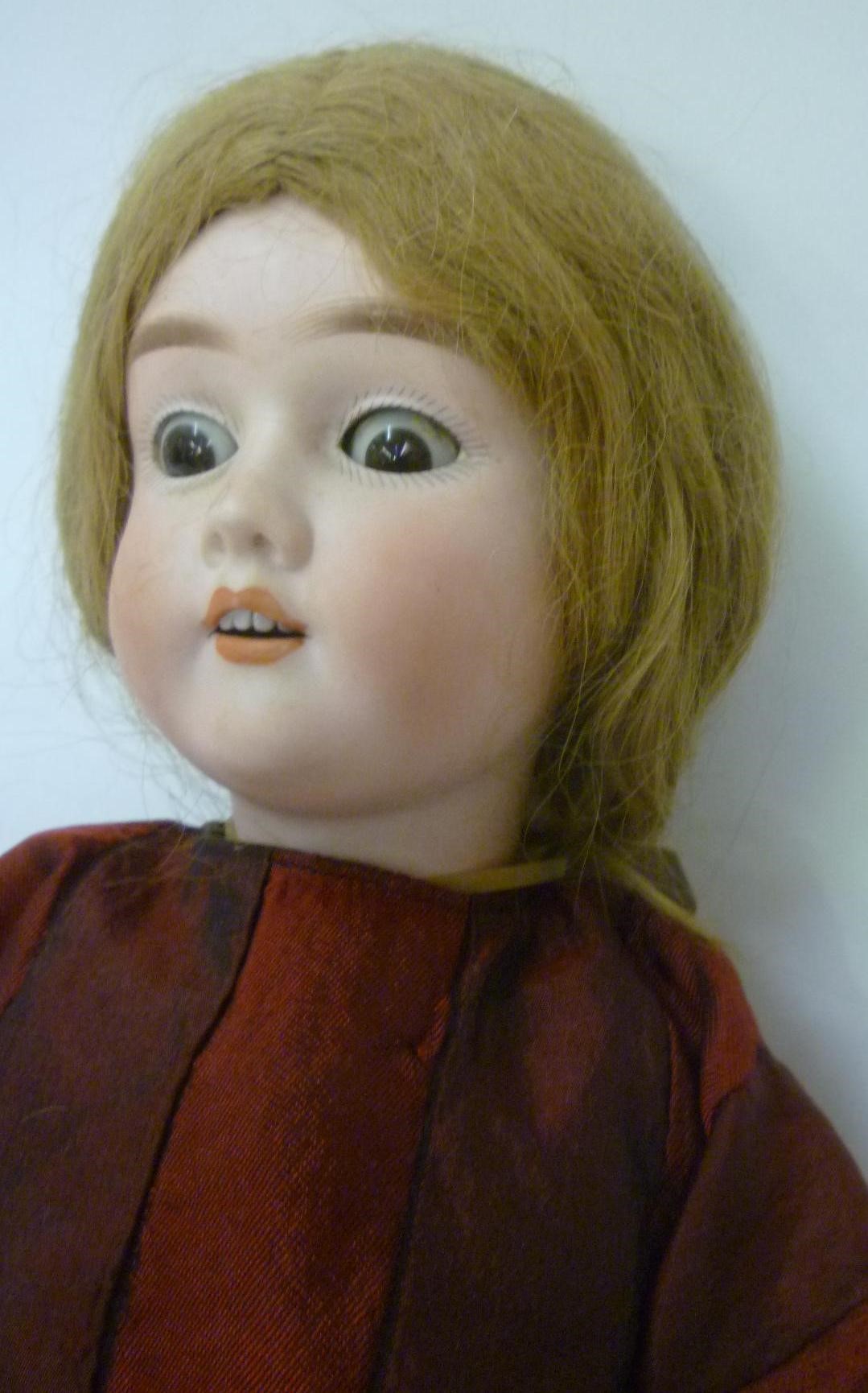A Heinrich Handwerck bisque head doll with brown glass sleeping eyes Image
