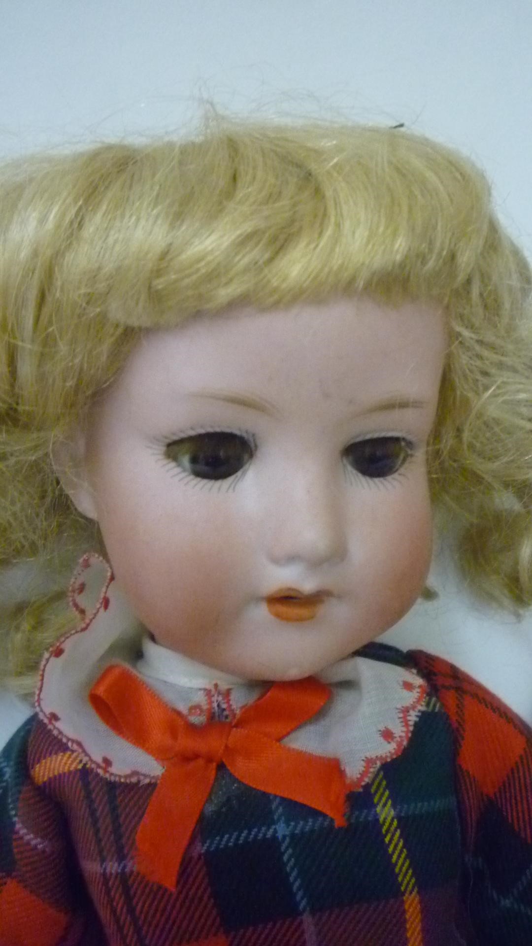 An Armand Marseille bisque head doll with brown glass sleeping eyes Image