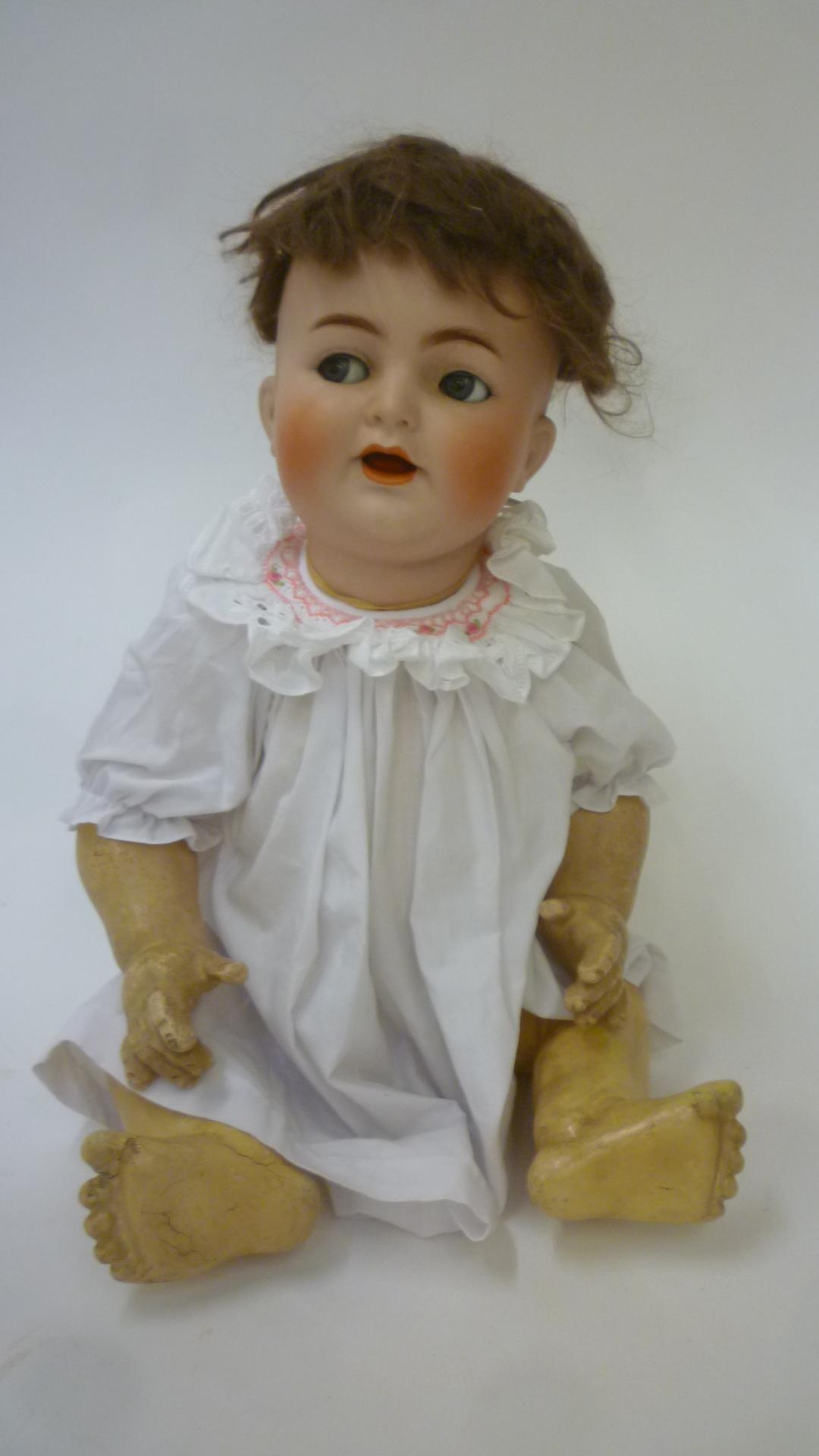 A Kammer & Reinhardt bisque head character doll with blue glass flirty eyes Image