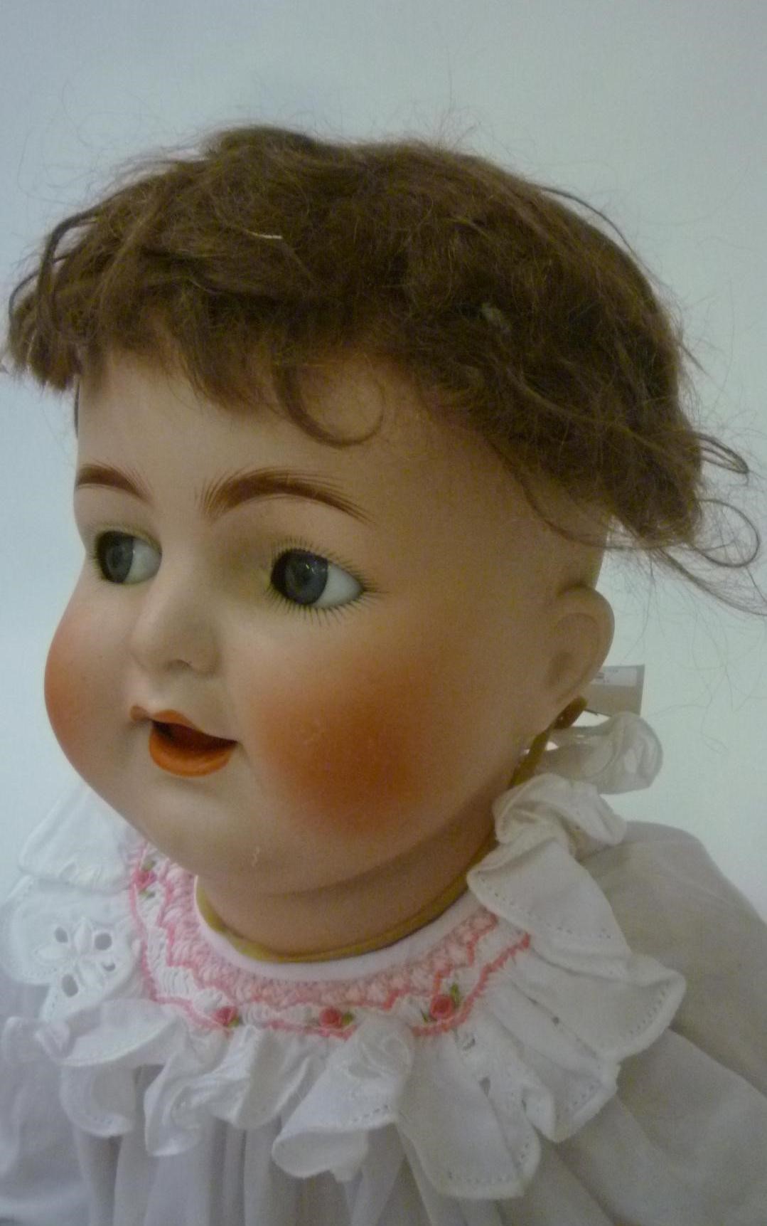 A Kammer & Reinhardt bisque head character doll with blue glass flirty eyes Image