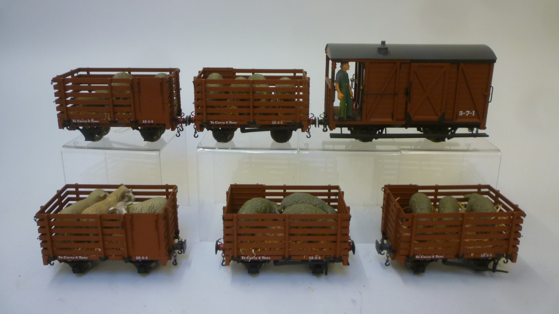 Five live stock wagons with sheep and straw load together with a large brake van Image