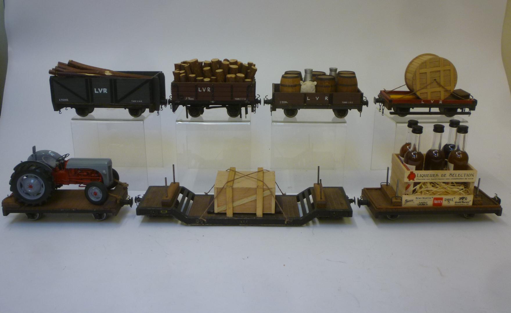 Seven goods trucks comprising two with wooden load Image