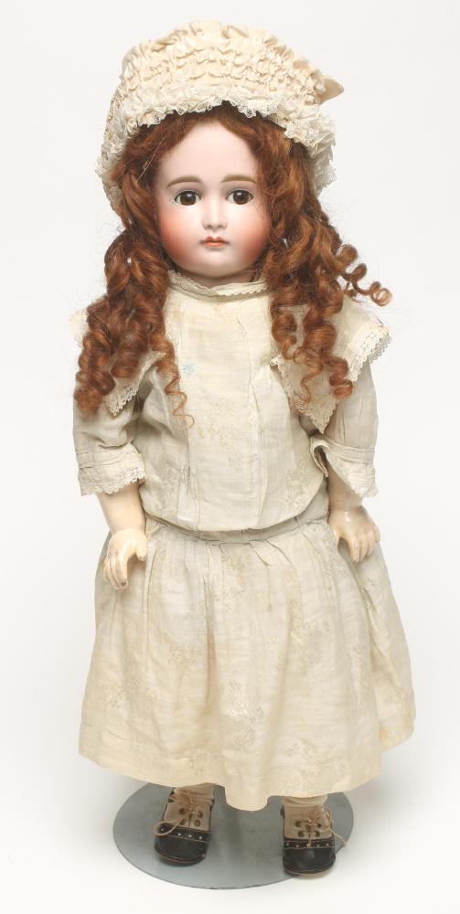A Kestner bisque head doll with brown glass sleeping eyes Image