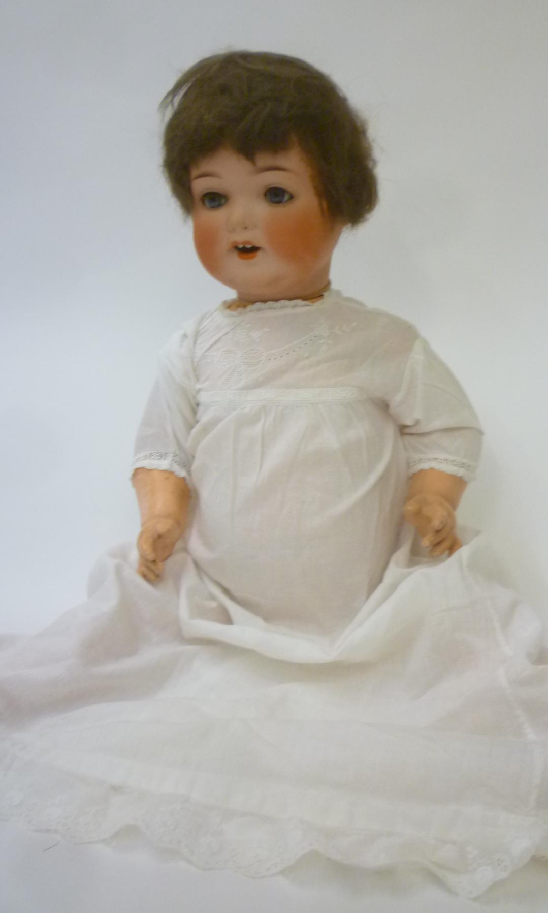 An Armand Marseille bisque head character doll with blue glass sleeping eyes Image