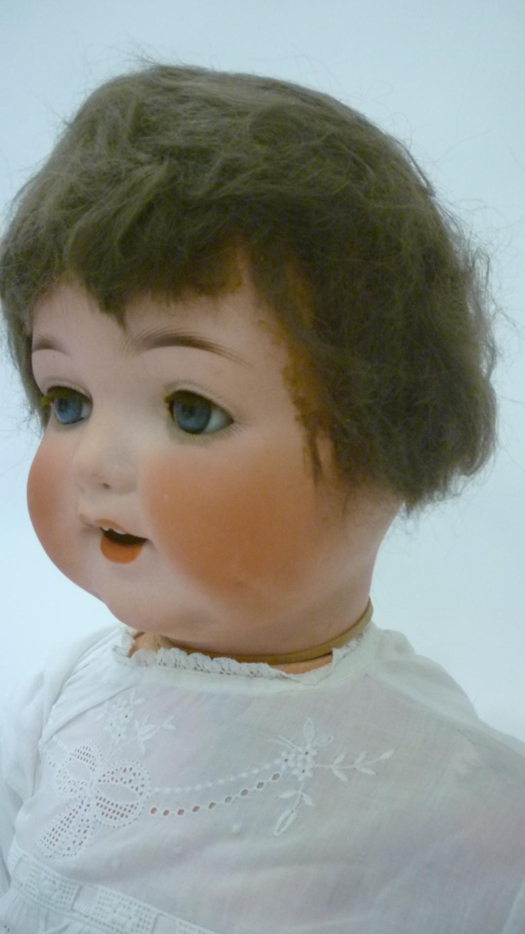 An Armand Marseille bisque head character doll with blue glass sleeping eyes Image