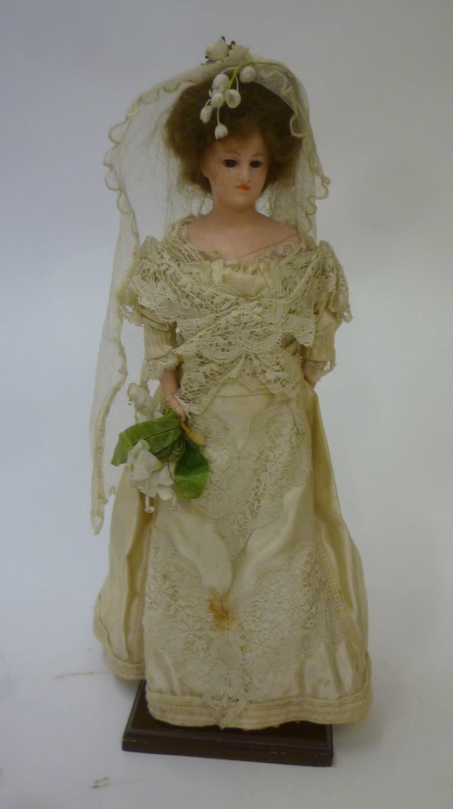 A wax shoulder head bride doll with fixed brown glass eyes Image