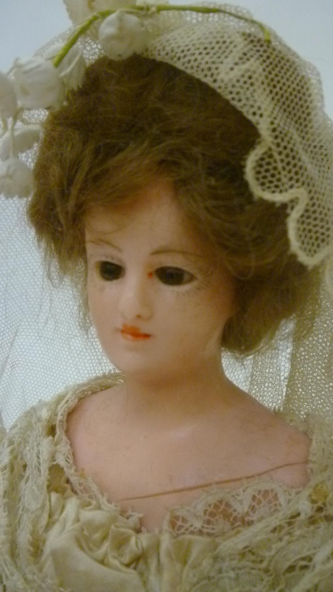 A wax shoulder head bride doll with fixed brown glass eyes Image