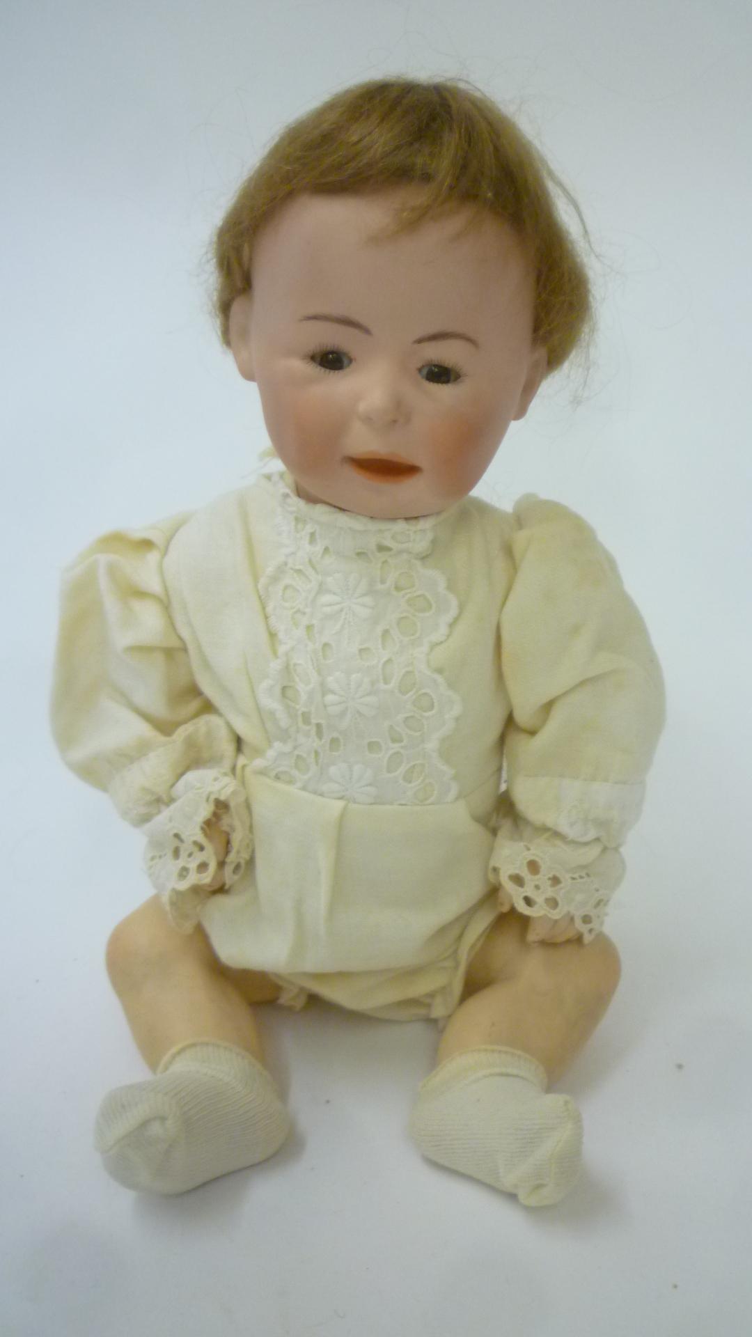A German bisque head character boy doll with brown glass sleeping eyes Image