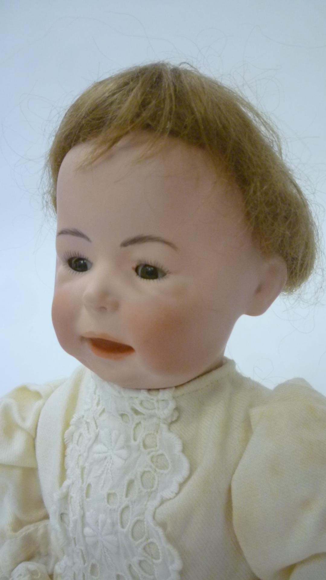 A German bisque head character boy doll with brown glass sleeping eyes Image