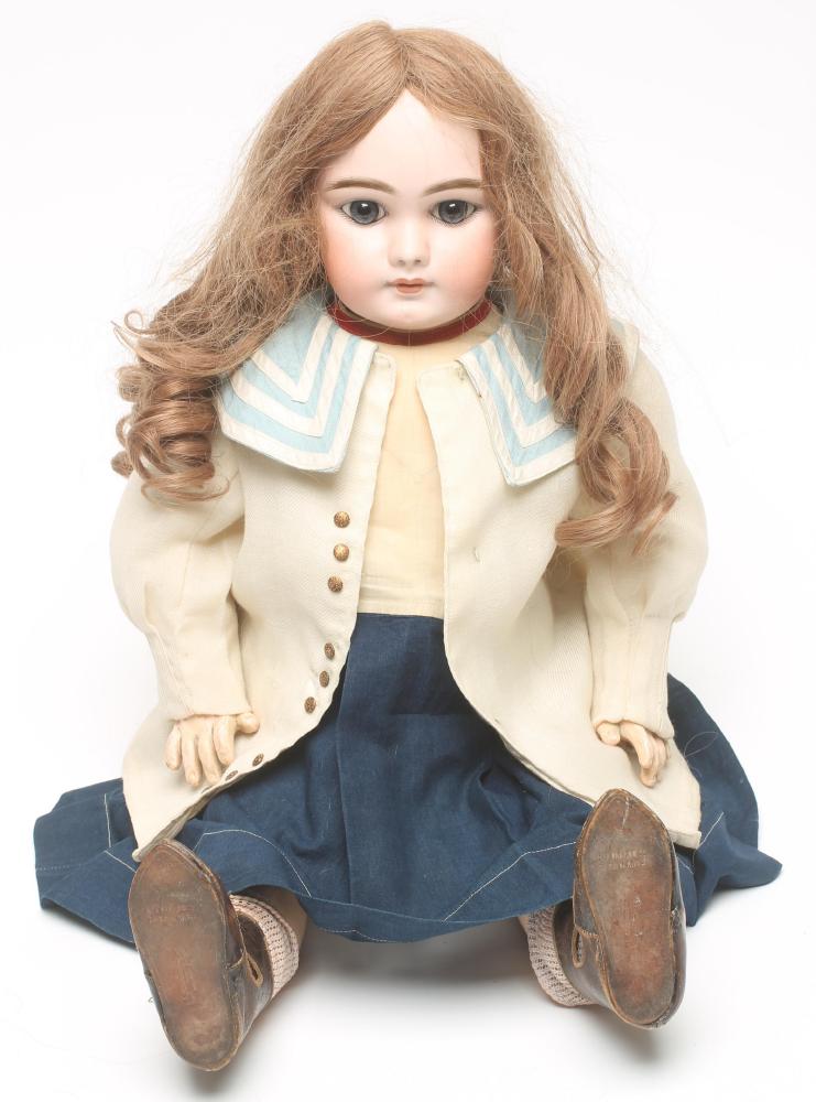 A Jumeau head character doll with fixed blue glass eyes Image