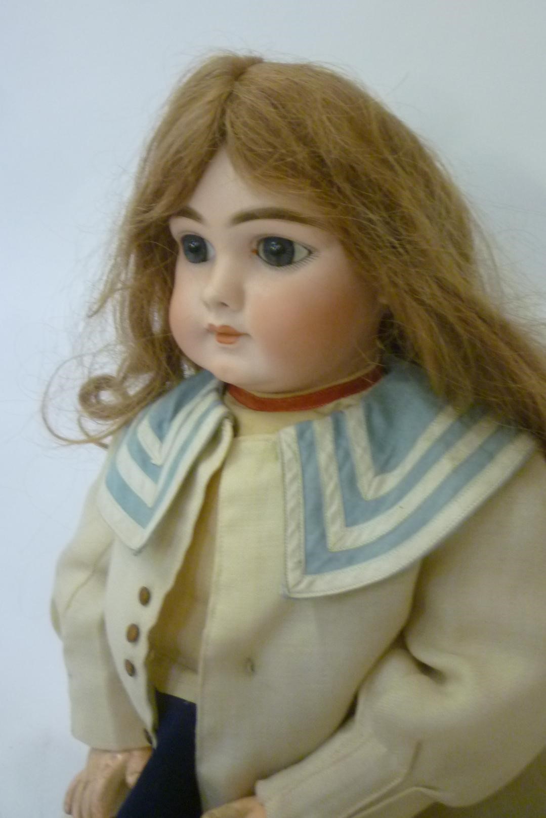 A Jumeau head character doll with fixed blue glass eyes Image