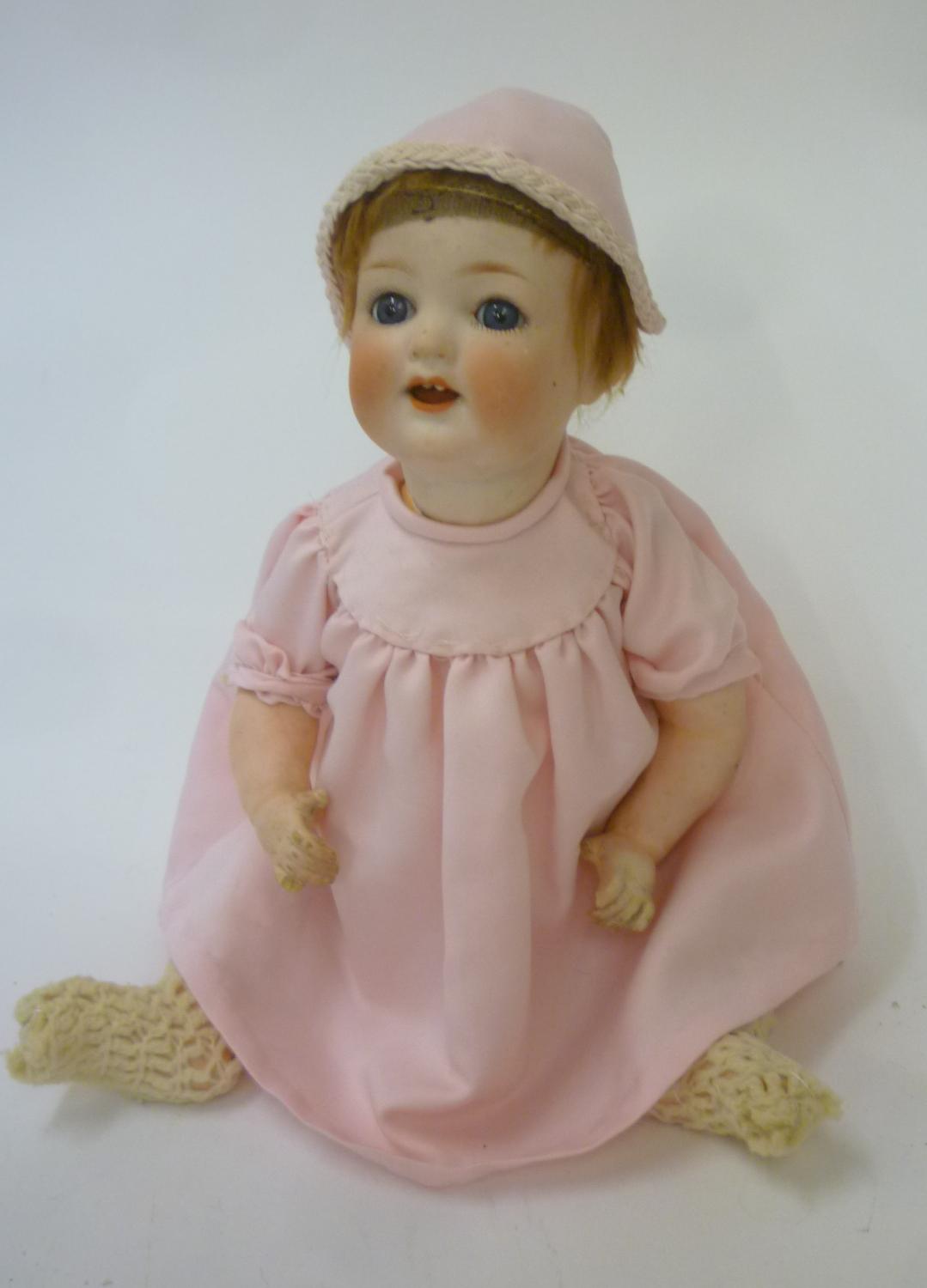 An Ernst Heubach bisque head character doll with blue glass sleeping eyes Image