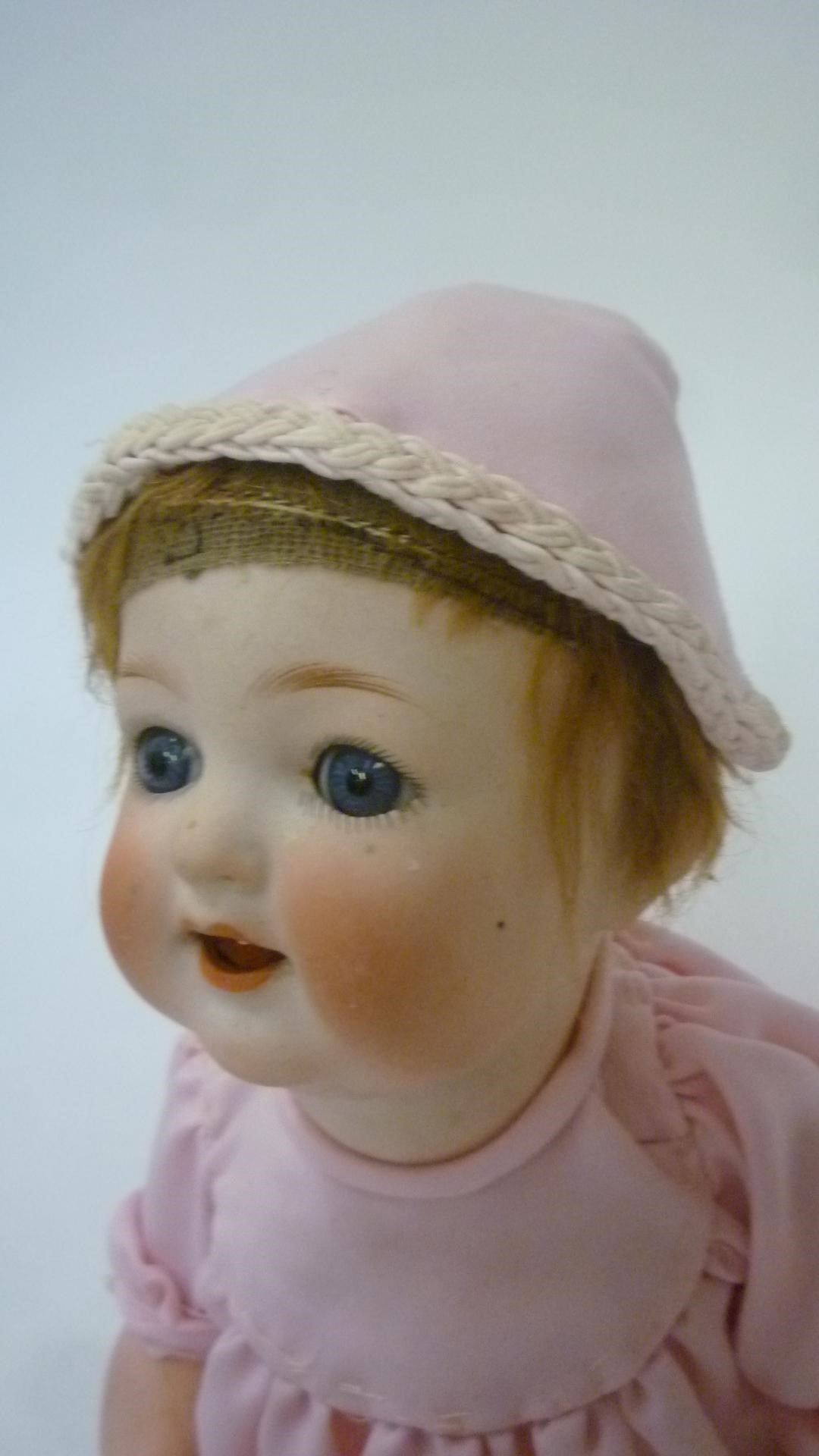 An Ernst Heubach bisque head character doll with blue glass sleeping eyes Image