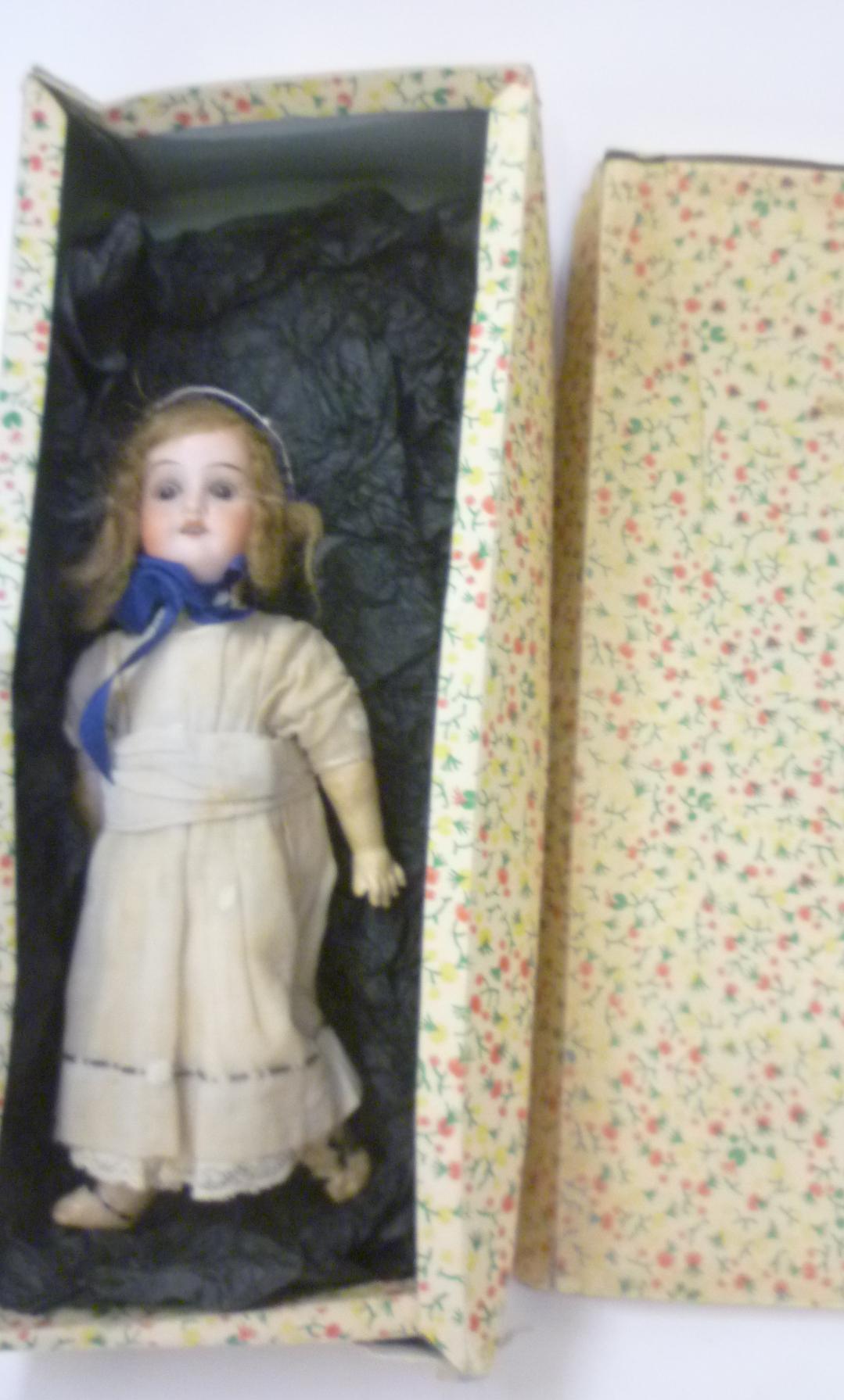 A Theodor Recknagel bisque head doll with brown glass sleeping eyes Image