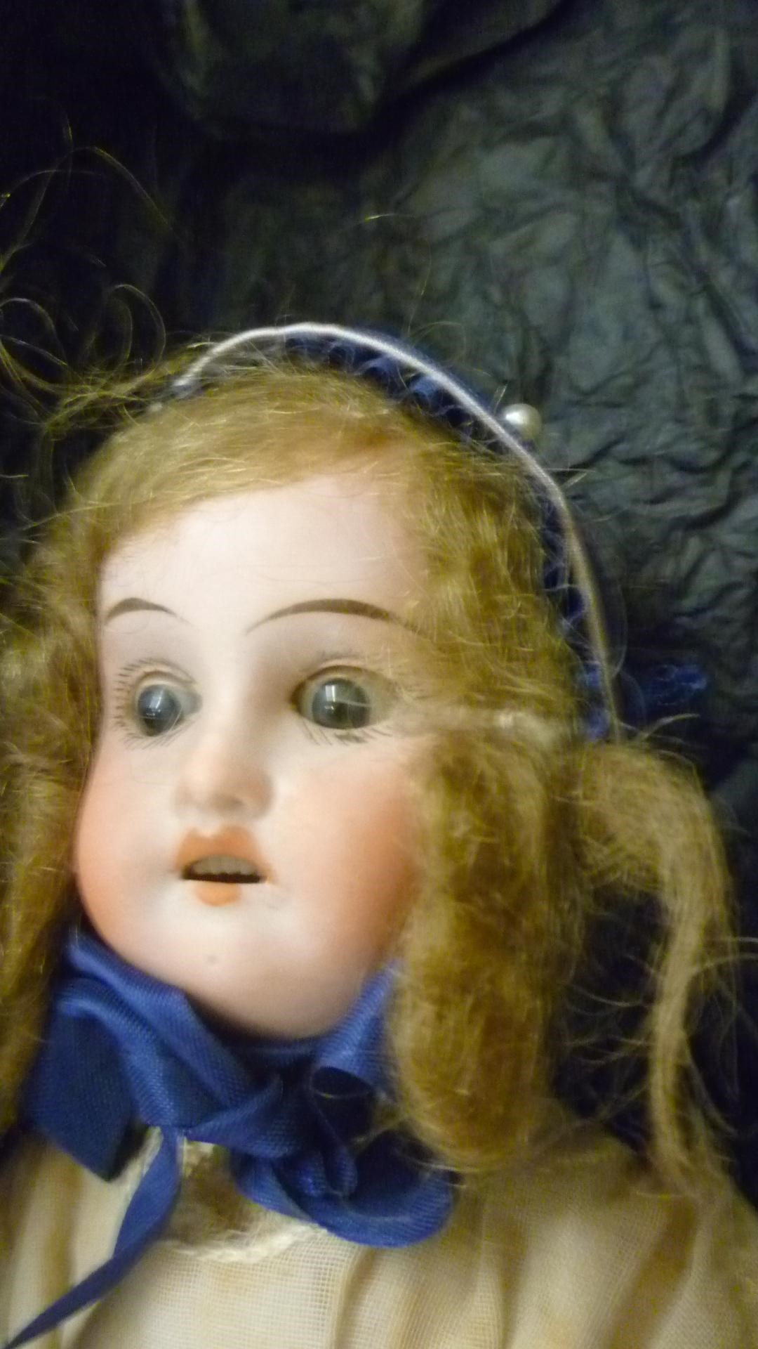 A Theodor Recknagel bisque head doll with brown glass sleeping eyes Image