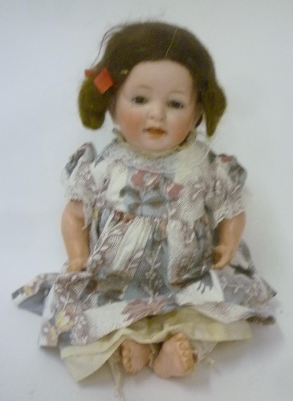 A Kestner bisque head character doll with brown glass sleeping eyes Image