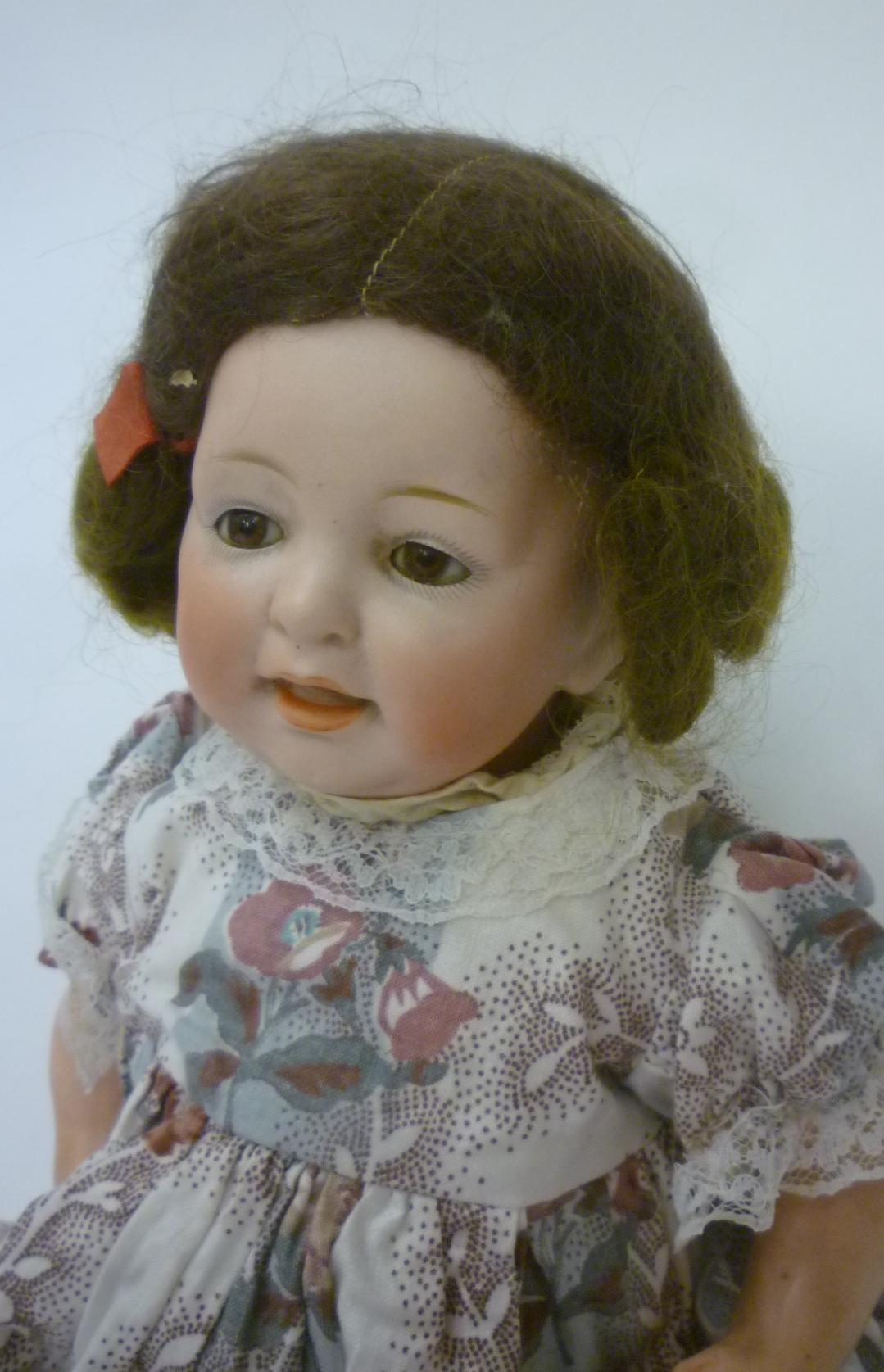 A Kestner bisque head character doll with brown glass sleeping eyes Image
