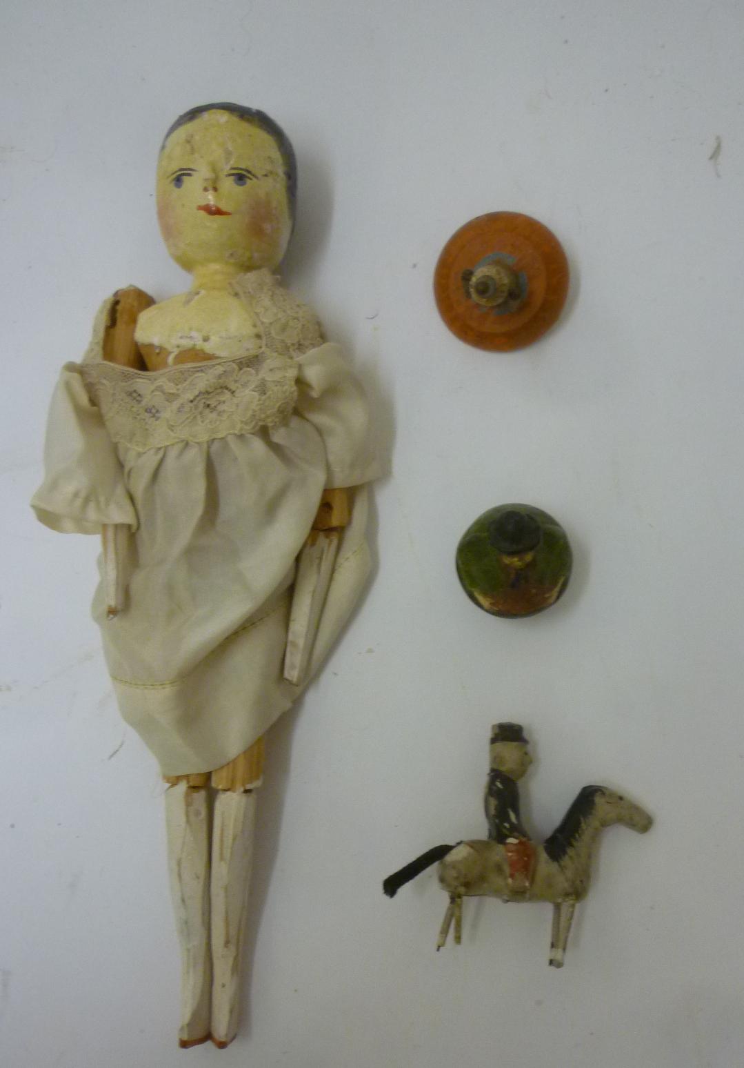 A Groderthal carved pine peg doll with painted head and shoulders and jointed limbs Image