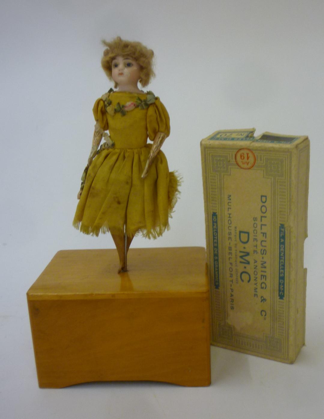 A bisque shoulder head dancing doll with blonde wig Image