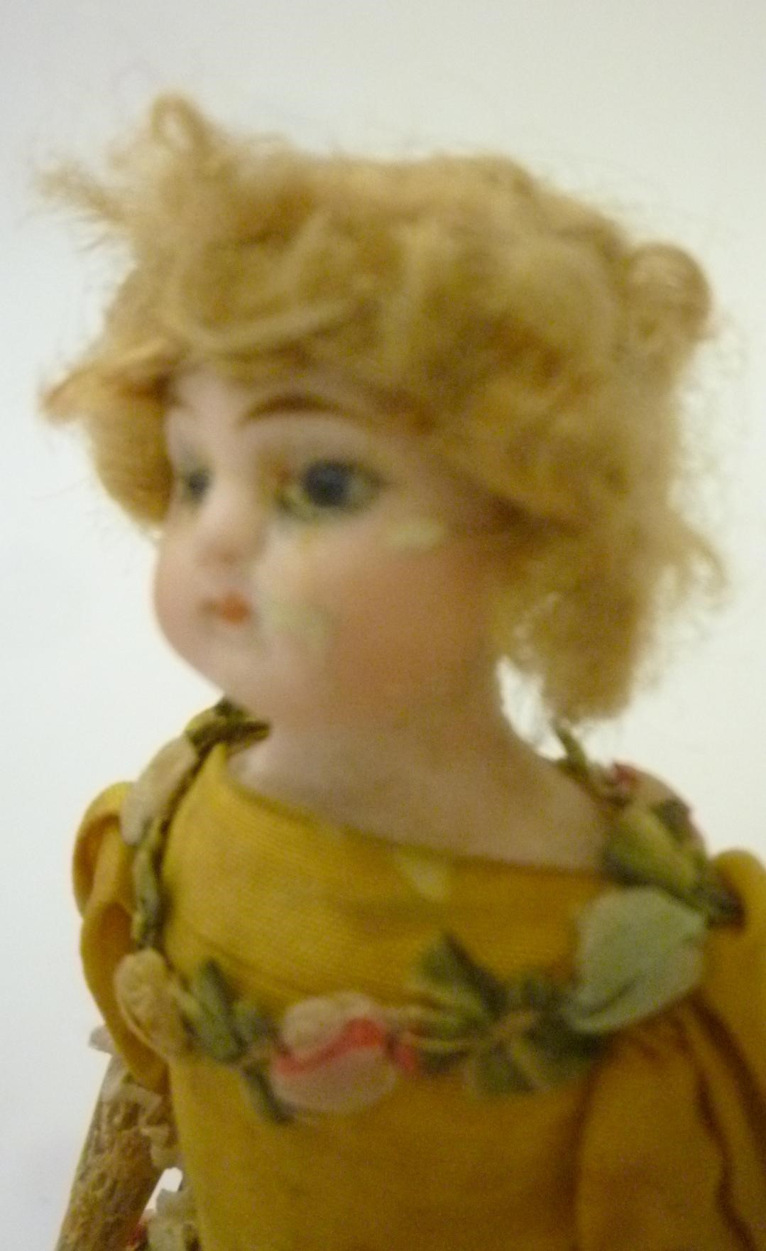 A bisque shoulder head dancing doll with blonde wig Image