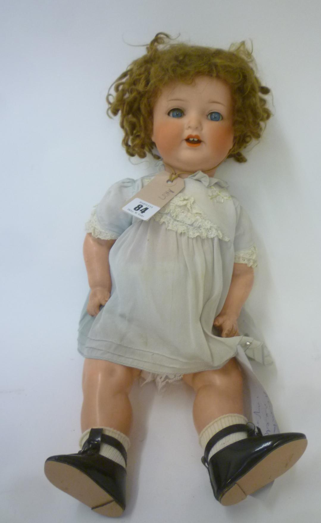An Armand Marseille bisque head character doll with blue glass sleeping eyes Image