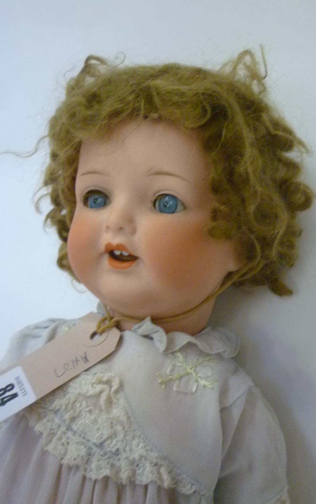 An Armand Marseille bisque head character doll with blue glass sleeping eyes Image