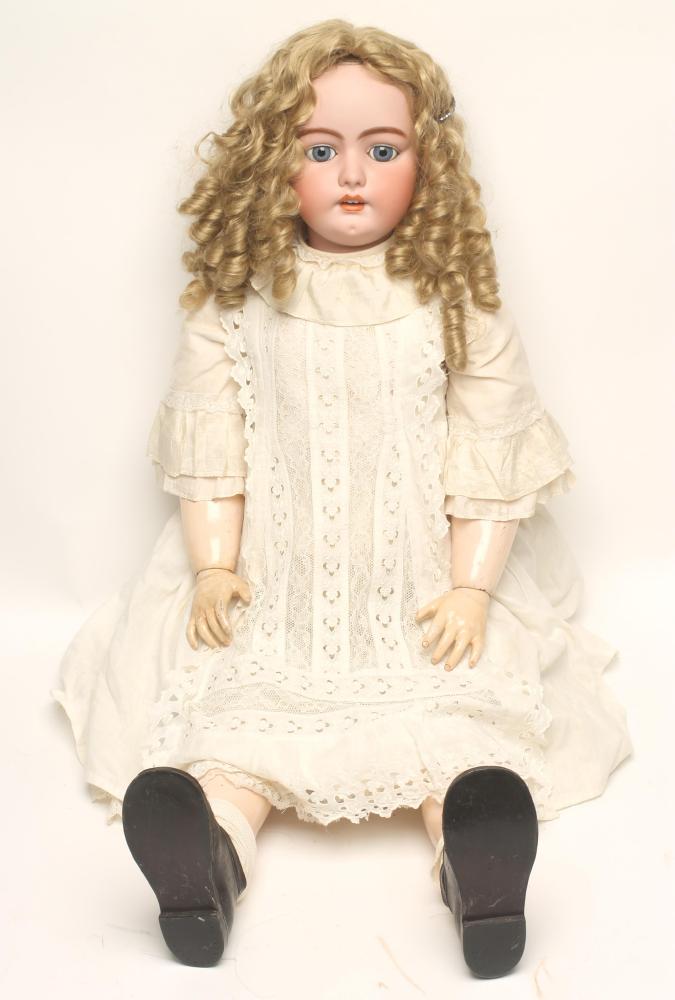 A large Simon & Halbig bisque head doll with fixed blue glass eyes Image