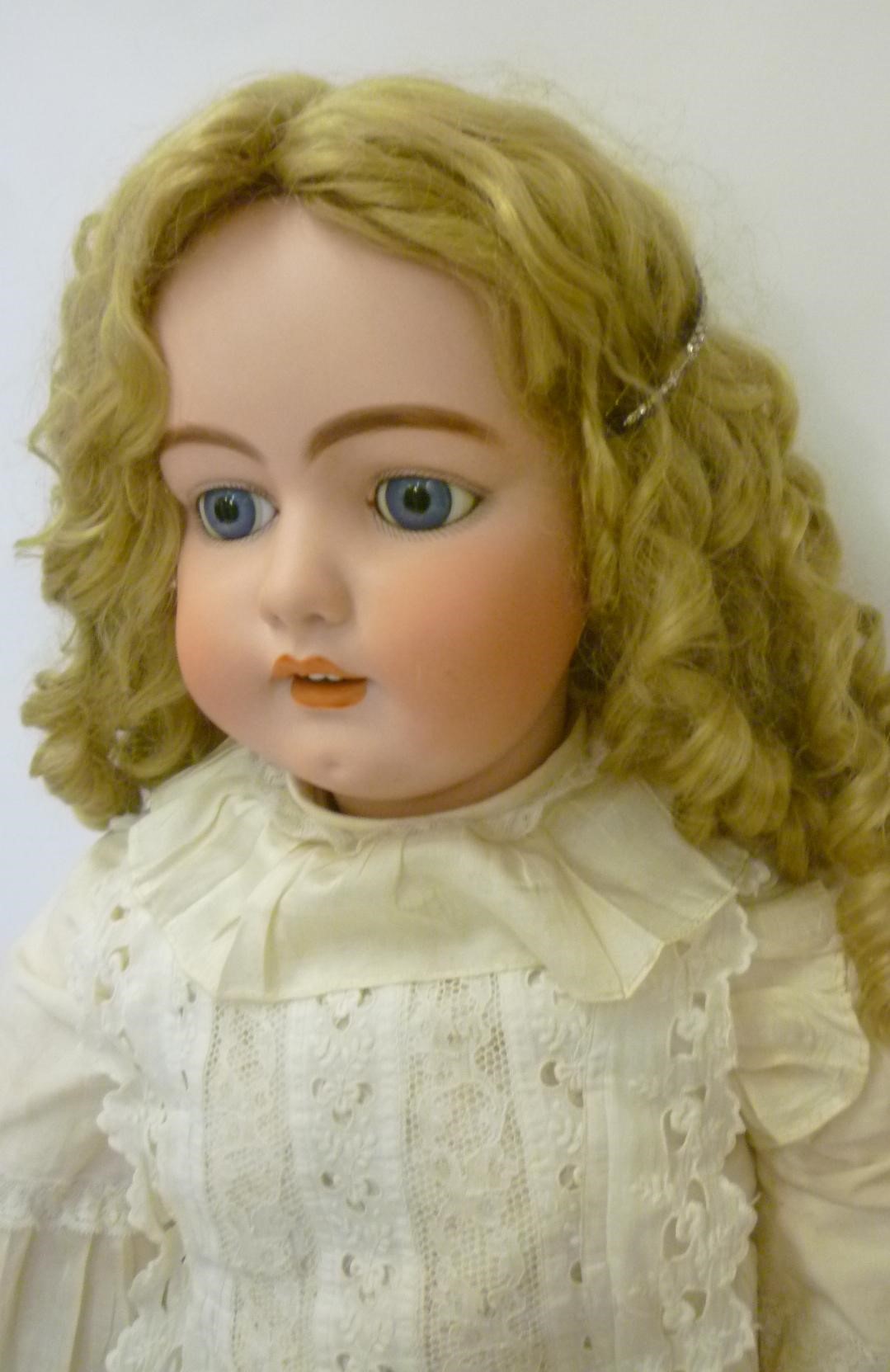 A large Simon & Halbig bisque head doll with fixed blue glass eyes Image