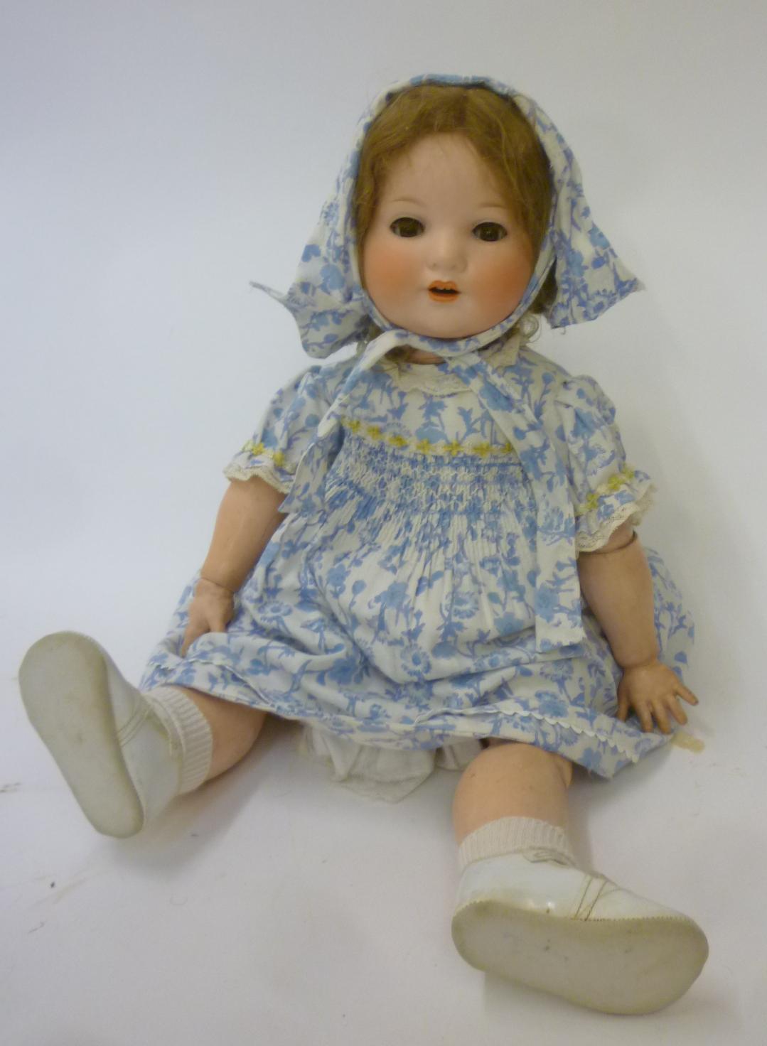 An Armand Marseille bisque head character doll with brown glass sleeping eyes Image