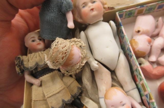 Sixteen jointed all bisque dolls house dolls Image