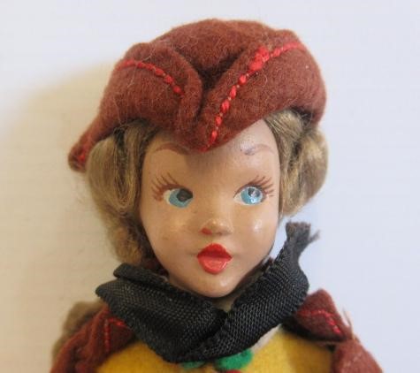 Three dolls comprising a circa 1900 10" wooden maid doll Image