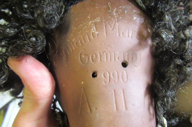 A Simon & Halbig bisque socket head mulatto doll Image