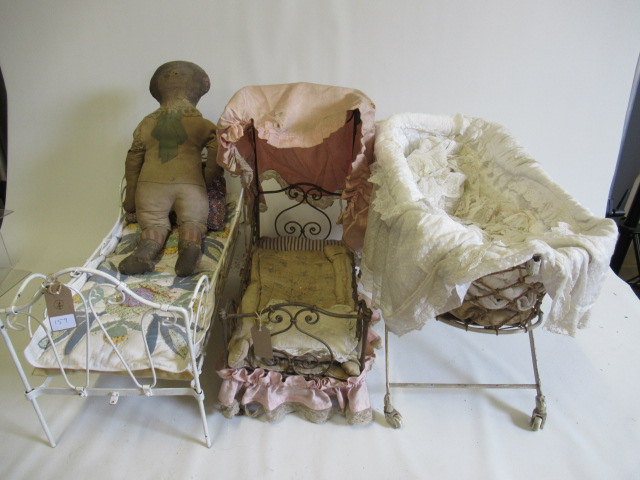 Two dolls beds and a raised crib Image