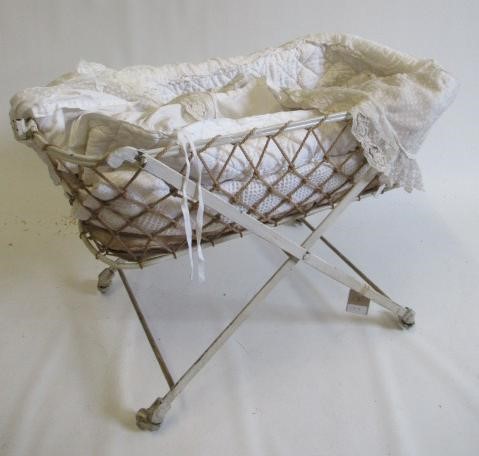 Two dolls beds and a raised crib Image